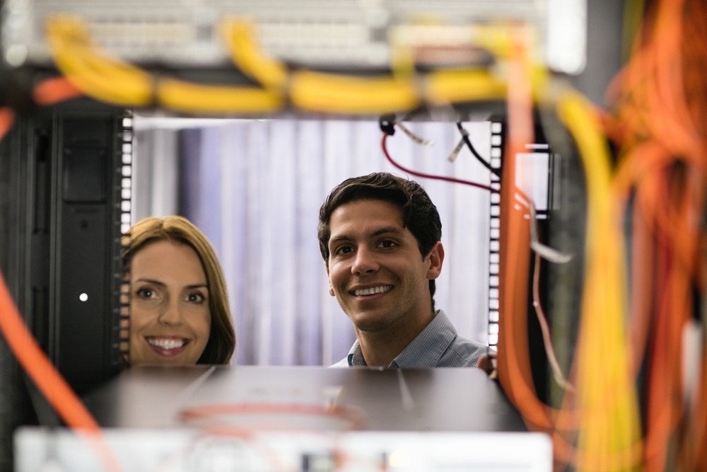 Team of technicians working together on servers at the data centre