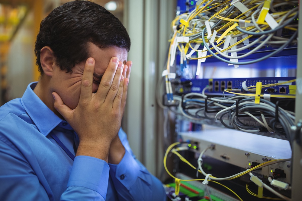 Technician getting stressed over server maintenance in server room-1