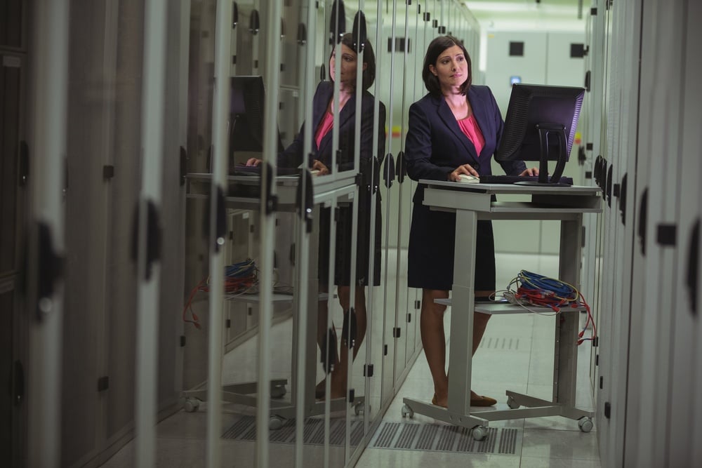Technician personal computer while analyzing server in server room