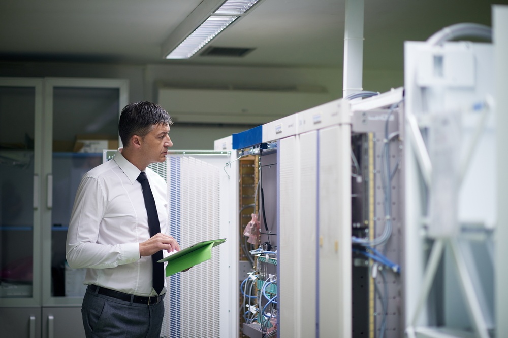 network engineer working in  server room, corporate business man working on tablet computer-1