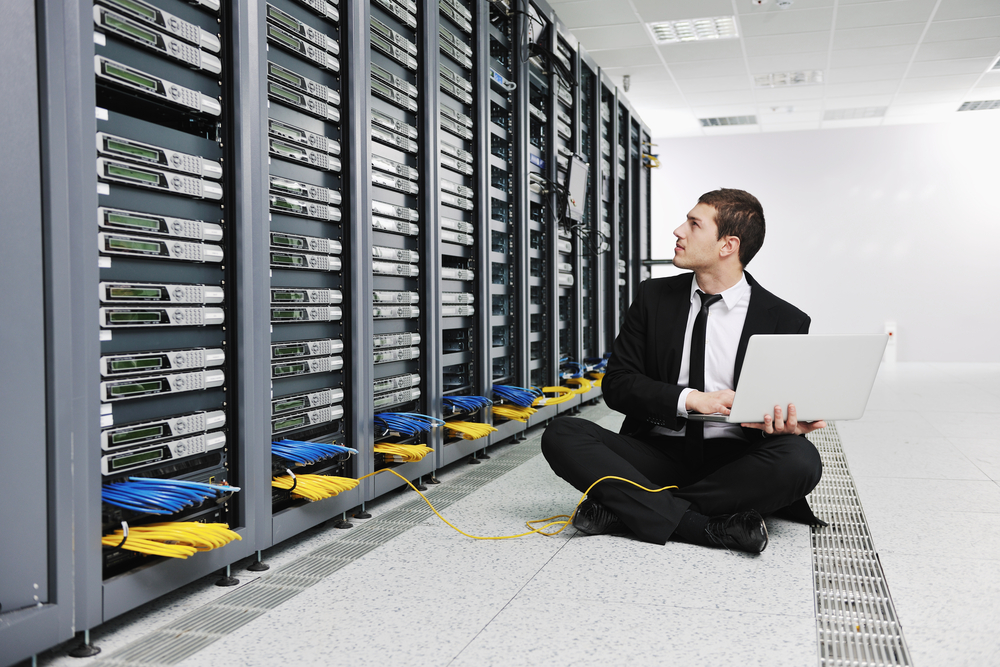 young engeneer business man with thin modern aluminium laptop in network server room-4